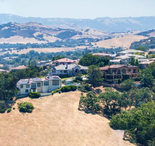 Luxury homes with mountain views in the background. 