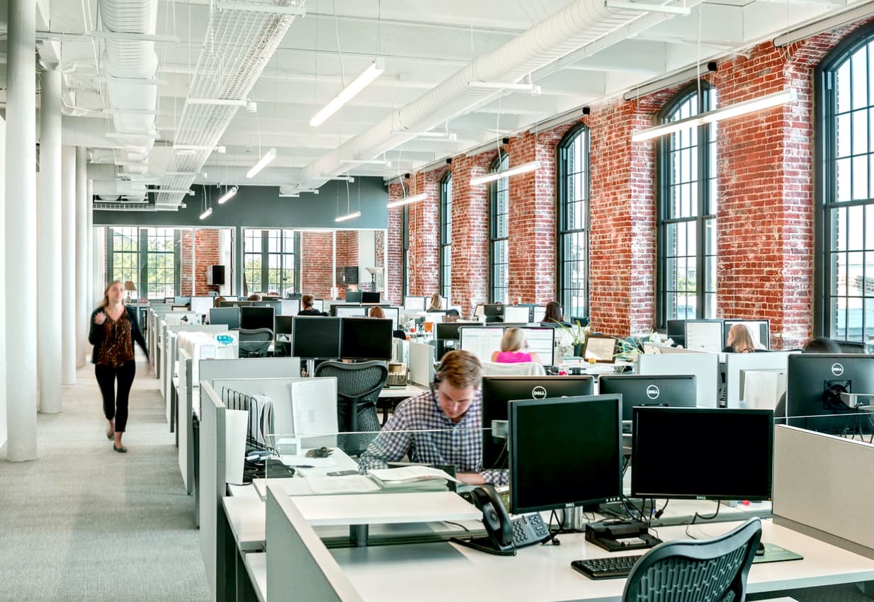 Employees working in modern office space. 