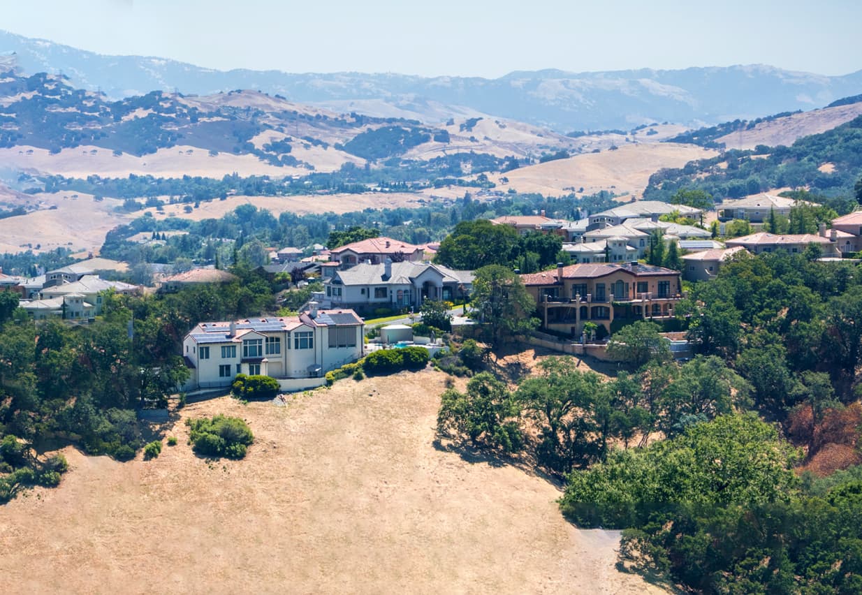 Luxury homes with mountain views in the background. 