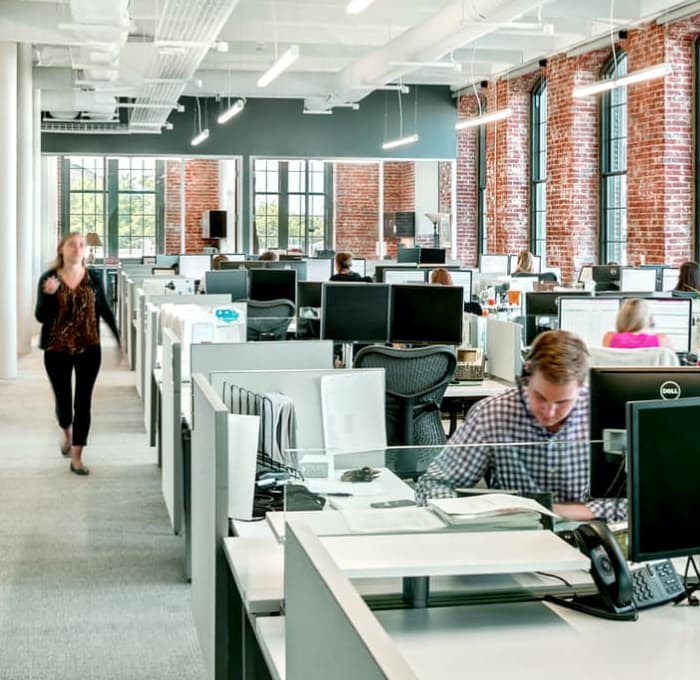 Employees working in modern office space. 